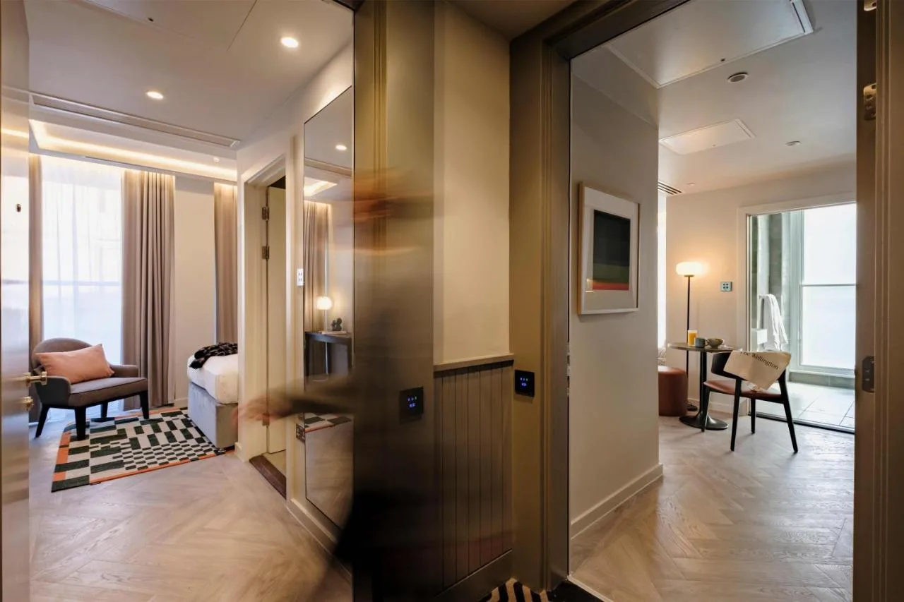 A hallway leading to a studio room at The Wellington Glasgow by Adina