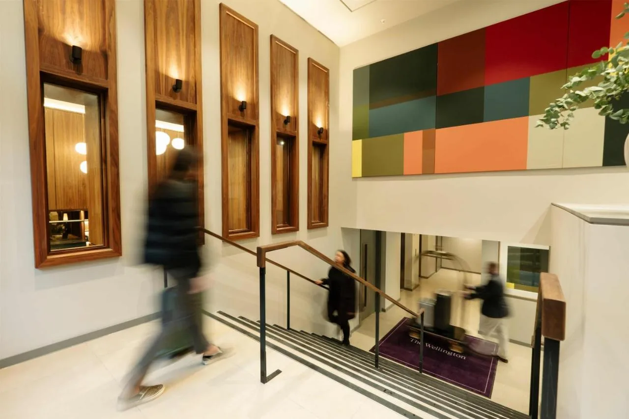 Guests walking down a staircase inside The Wellington Glasgow by Adina
